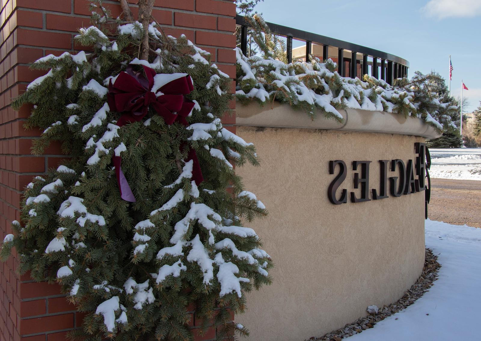 Snow on campus entrance sign